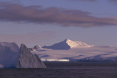 Sunlight catches a large tabular iceberg by the coast of the Tabarin Peninsula. Antarctic Peninsula.