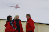 Passengers on the Kapitan Dranitsyn on the bow deck as a helicopter flies by. Antarctica