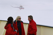 Passengers on the Kapitan Dranitsyn on the bow deck as a helicopter flies by. Antarctica