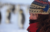 Tourist wrapped up well against the cold at an emperor penguin colony. Antarctica