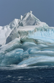 Dramatic iceberg with layers of blue and white ice, all eroded by the sea. Weddell Sea. Antarctica.