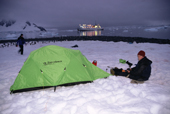 Adventure tourism in a tent at Paradise Harbour. The Professor Multanovsiy sits at anchor. Antarctica