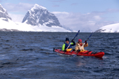 Eco tourists in a double kayak near Port Lockeroy. Antarctica