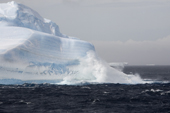 Waves break agains the bottom of a large iceberg on a stormy day in Erebus & Terror Gulf. Antarctic Peninsula