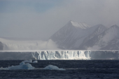 A large tabular iceberg catches the light on a windy day, Weddell Sea. Antarctica.