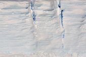 Crevasses in the side of a tabular icebergs, with the annual layers visible. Antarctica