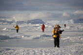 Tourists walk across the sea ice returning from the Emperor Penguin colony at Snow Hill Island. Antarctica