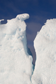 Detail of an iceberg crack against a blue sky. Antarctica