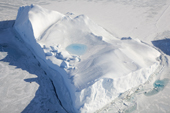 A pool of fresh water on the top of a thawing Iceberg. Antarctica