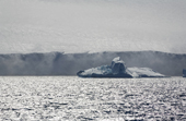 Katabatic wind blows snow off the top of a glacier in Antarctic Sound. Antarctica