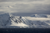 Mountains and bands of cloud and high wind in the Gerlache Strait. Antarctic Peninsular