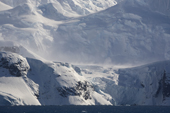 Katabatic winds blow over the lower glaciers on a glaciated mountain side. The Gerlache Strait. Antarctic Peninsular