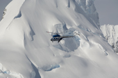 Russian Mi-2 helicpter from the Kapitan Khlebnokov flies past glaciers in the Gerlache Strait. Antarctic Peninsula