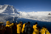 Tourists on the flying bridge as they pass through the Lemaire Channel. Antarctica