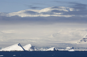 Mountains and Glaciers on the Antarctic Peninsula are draped in layers of cloud.