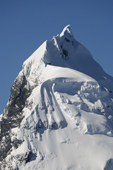 Mountain peak in Antarctica, draped with cornices and ice artifacts.