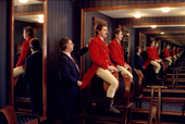 Fitting a horseman for his red hunting coat. Saville Row. London. England. 1988-89