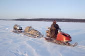 Nikolai Lukin, a Sami reindeer herder from Lovozero, taking supplies to his winter camp by snowmobile. Murmansk, NW Russia. 2005