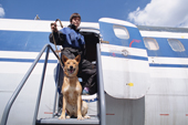 Dog handler, Eleana Batayeva, with Reed, a dog/jackal cross, that is trained to detect explosives at Sheremetyevo Airport, Moscow, Russia. 2005