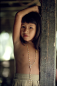 Mentawai girl watches from the door of the Uma. Siberut. Indonesia.