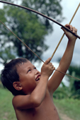 Mentawai boy plays with bow & arrow & shooting monkeys. Matotonan. Siberut.Indonesia