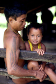 Young Mentawai man with young boy. Siberut Island, Indonesia.