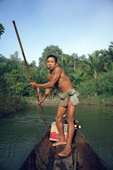 Mentawai man in his dugout canoe goes up to his village Siberut Is. Indonesia.
