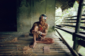 Mentawai medicine man making arrows to shoot monkeys. Siberut Island, Indonesia.