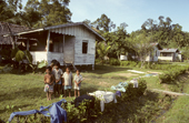Young Mentawai children in front of a house, at the new government social village at Puro. Siberut Island, Indonesia