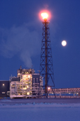 Full moon & a flare at Endicott Oil Production Island. Prudhoe Bay on the North Slope. Alaska. USA. 1989