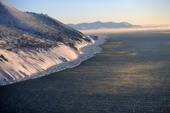 Bands of frost smoke hang over open water and new sea ice off Cape Prince of Wales on the Bering Strait. Alaska. 2003