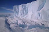 Ice cliff and wind sculpted snow at its base. Part of the Ekstrom Ice Shelf. Weddell Sea. Antarctica