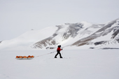 Margot pulls her man haul pulk along the base of Patriot Hills, West Antarctica
