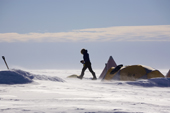 Field Guide Margot crosses camp at Patriot Hills in a wind. Antarctica