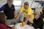 Geologist, Ian Dalziel, Radio engineer, Alan Cheshire, Denise and Lee discuss the Coriolis effect with the help of an orange and a GPS. Patriot Hills. Antarctica