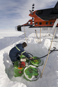Refuelling a Twin Otter at Theal from a buried fuel cache on the way to the South Pole. Antarctica