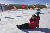 Ezra Marcus leans against the Ceremonial South Pole on his visit there. Antarctica