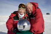 Connie & Martin Mandles pose by the reflecting globe at the Ceremonial South Pole. Antarctica