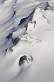 Rocky peak in the Ellsworth Mountains with a dramatic wind scoop, and an Arete running diagonally. West Antarctica