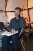 Radio Operator Jason checks with groups in the field on an Iridium telephone. Patriot Hills. ALE's Antarctic Headquarters.