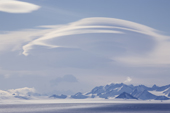Blue ice in front of the Ellsworth Mountains, with Orographic clouds over the peaks. Antarctica