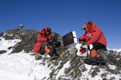 Robert Smalley & associate set up a GPS receiver collecting data in West Antarctica, part of the WAGN Project to measure movement of land & ice. Patriot Hills. Antarctica