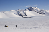 Antarctic Ice Marathon runners run past the film & still cameramen as they pass MT Fordell. Patriot Hills. Antarctica