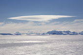 Stratocumulus cloud hangs over the Ellsworth Mountains while a higher stratus formation is backlit over the Polar Plateau. Antarctica