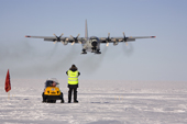 C130 equipped with skis coming in to land at Patriot Hills. ALE staff on the threshold. Antarctica