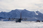 C130 equipped with skis on the skiway at Patriot Hills. ALE staff load it with American Scientists equipment. Antarctica