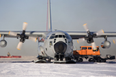 C130 equipped with skis on the skiway at Patriot Hills. ALE staff load it with American Scientists equipment. Antarctica