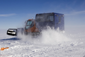 Turning the Camoplast in a high wind, with a plume of snow. Antarctica