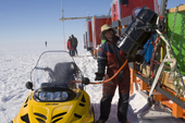 Scotty refuels a skidoo at the start of the day on the Chilean Traverse. Antarctica