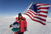 Denise with the Stars and Sripes at the Ceremonial South Pole. Antarctica